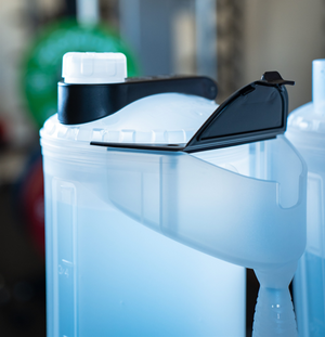 Close-up of a white water bottle with black cap and spout 