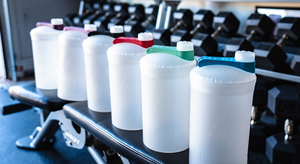 Row of BFB with colorful caps on a gym bench